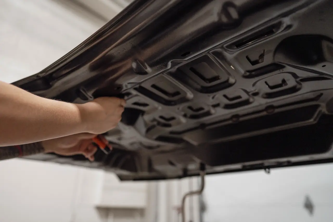 A technician working a panel with PDR tooling